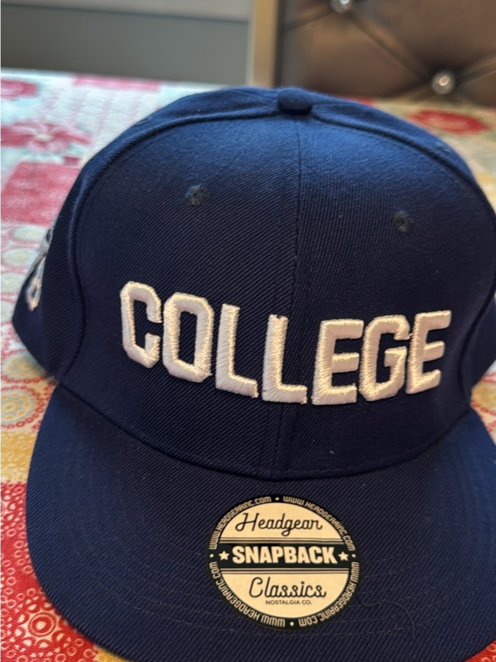 COLLEGE Embroidered Snapback Hat in Navy and White